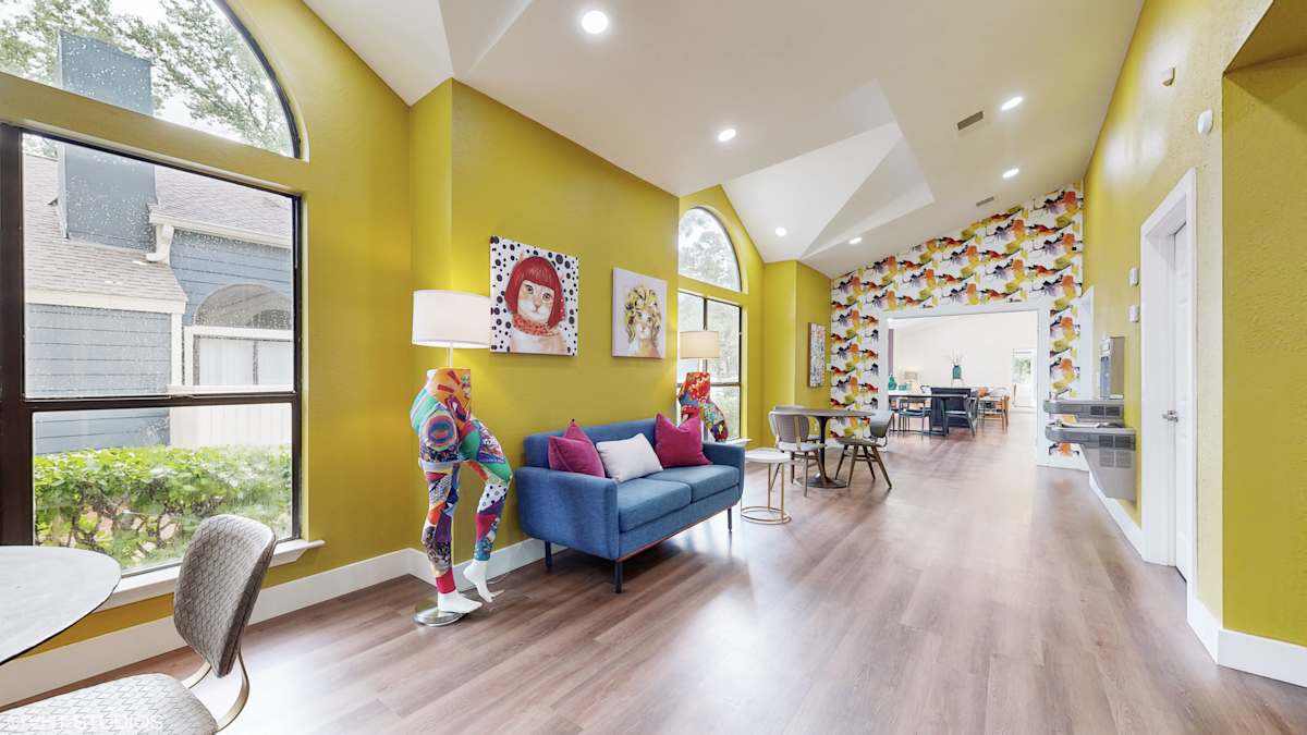 The Vale Apartments and Townhomes living room with yellow walls and blue couch - Cordova, TN
