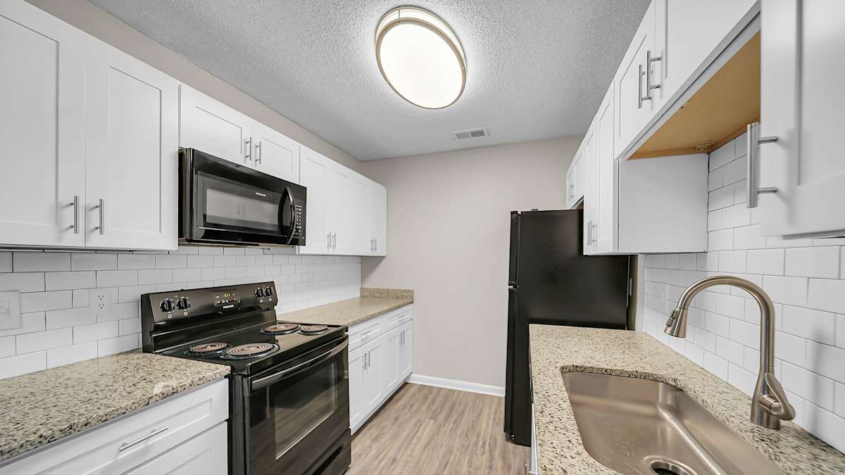 The Stella Apartments kitchen with black appliances - Memphis, TN