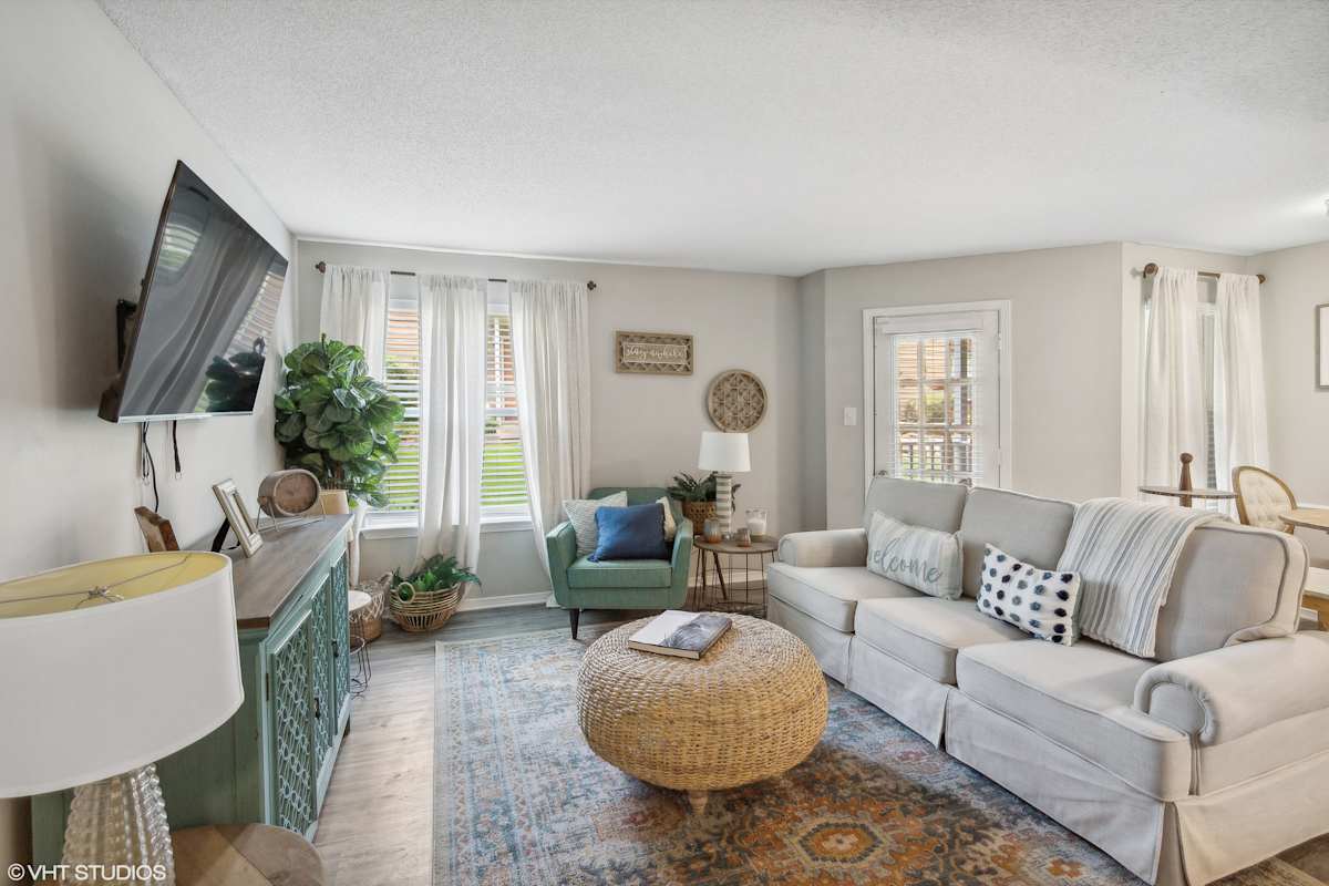 The Local Apartments staged living area with TV - Memphis, TN