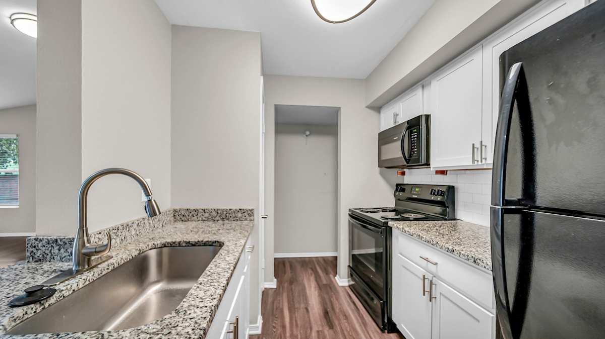 The Nova Apartments kitchen with stove and sink - Memphis, TN
