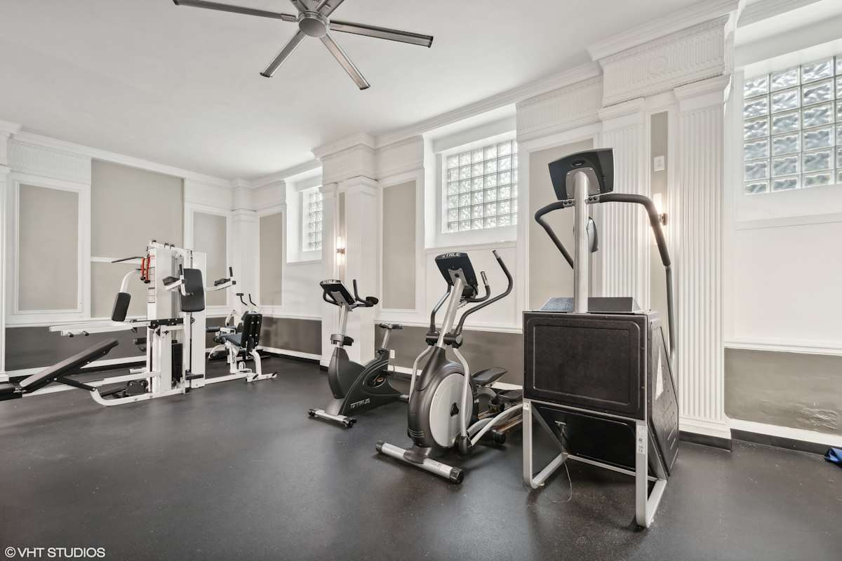 CWE Apartments gym equipment area with bike and elliptical - St. Louis, MO