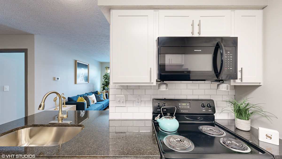 Springburne at Polaris Apartments kitchen with stove and microwave - Columbus, OH
