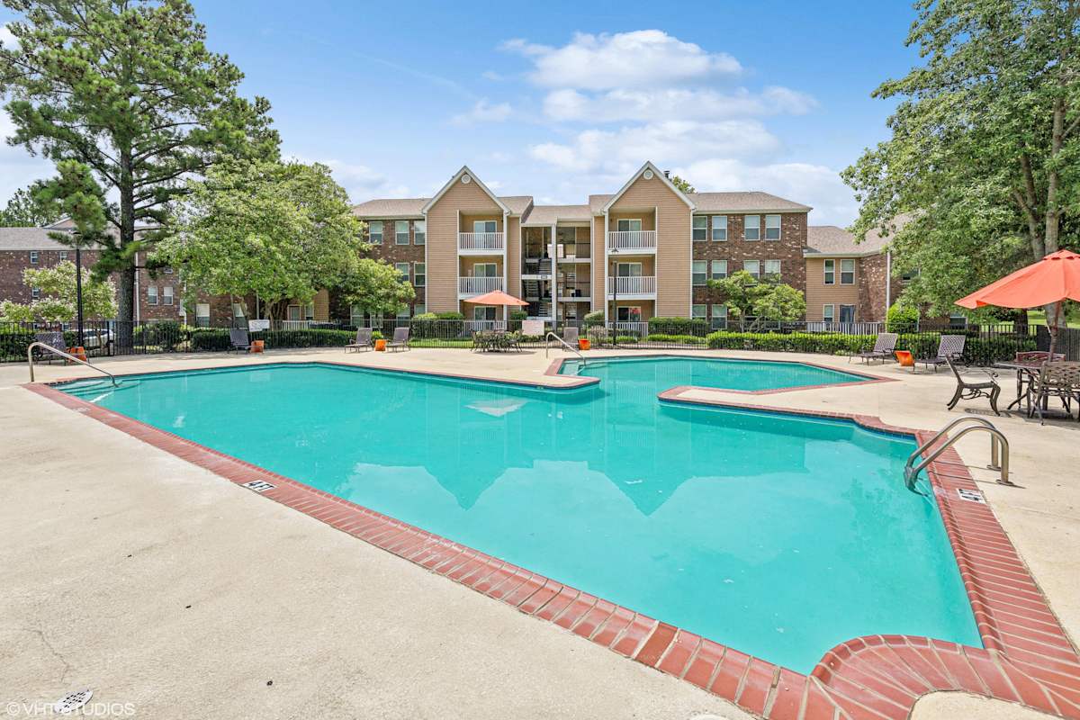 The Local Apartments pool with apartment buildings - Memphis, TN