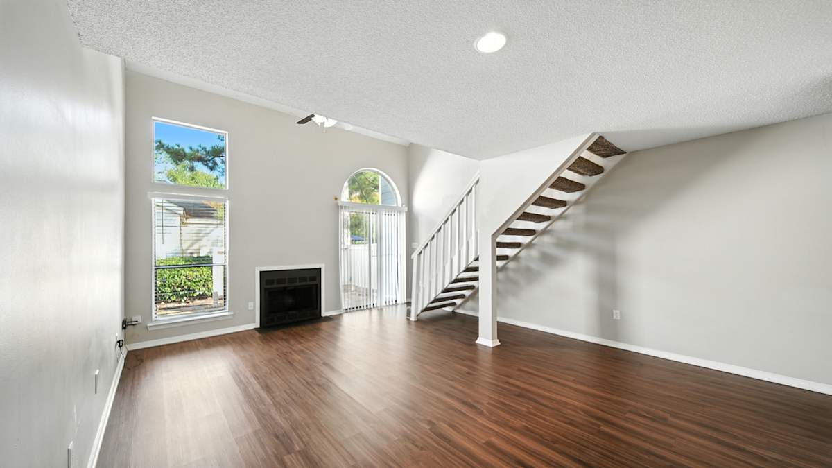 The Vale Apartments and Townhomes living area with staircase and fireplace - Cordova, TN