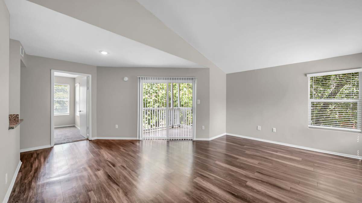 The Nova Apartments room with wood-style floors and window - Memphis, TN