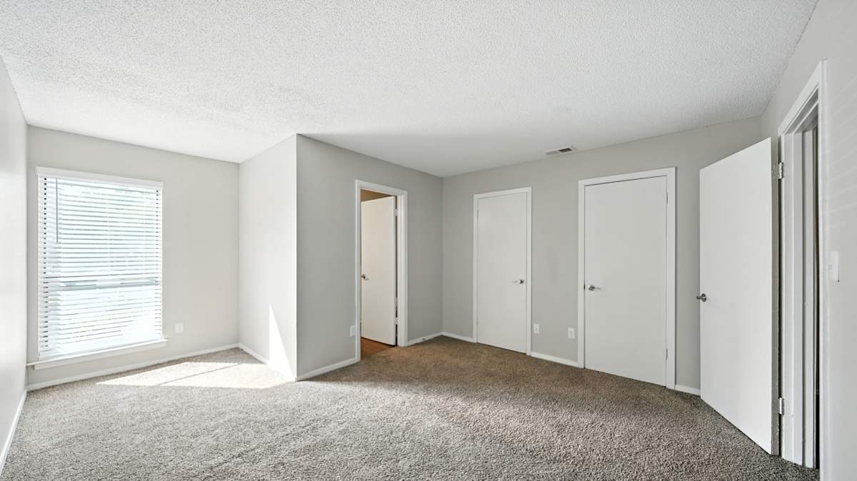 The Vale Apartments and Townhomes carpeted bedroom with white walls - Cordova, TN