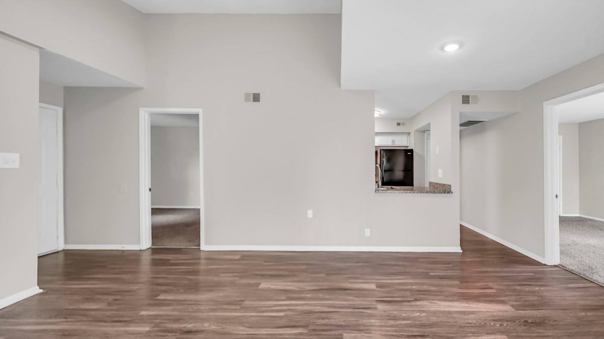 The Nova Apartments living room with wood-style flooring - Memphis, TN