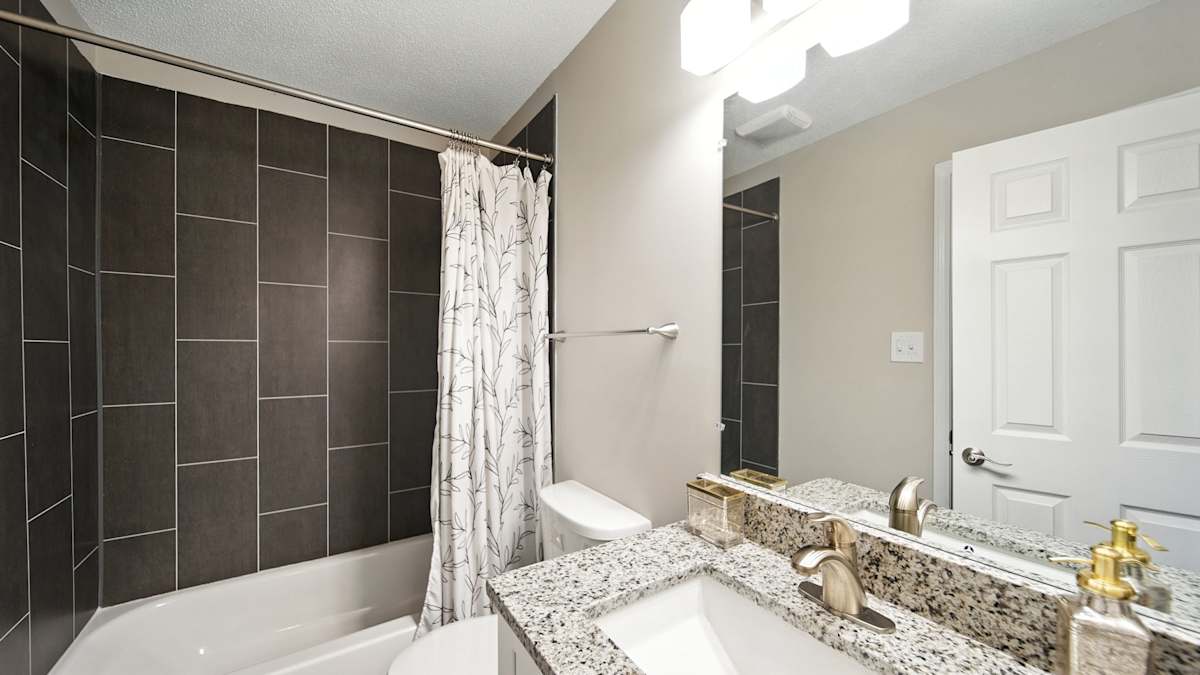 The Vale Apartments and Townhomes bathroom with tub and vanity - Cordova, TN