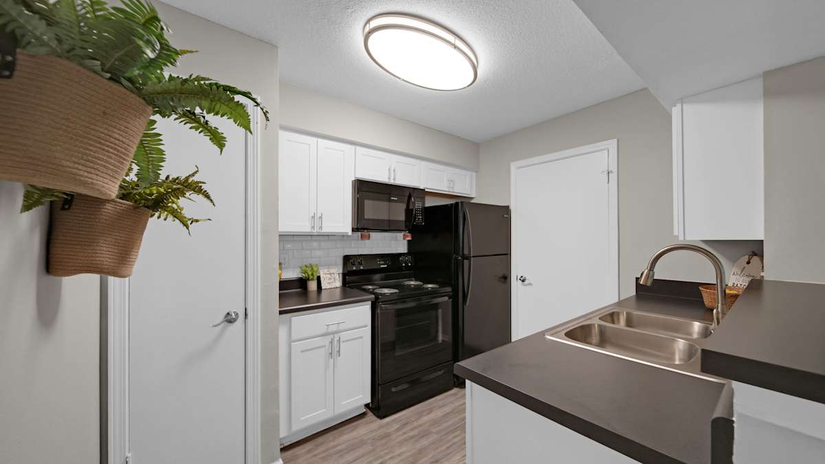 The Local Apartments kitchen with black refrigerator - Memphis, TN