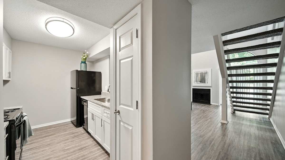 The Vale Apartments and Townhomes kitchen with white cabinets and black refrigerator - Cordova, TN