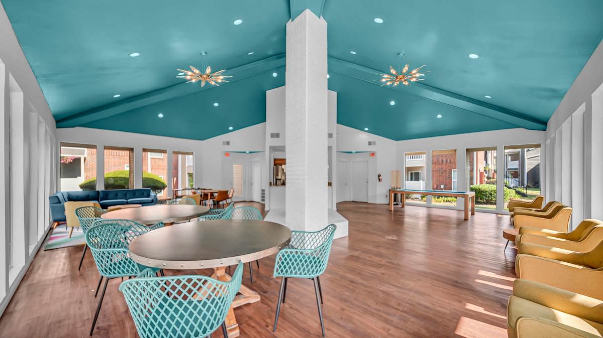 The Nova Apartments clubhouse seating area with table - Memphis, TN