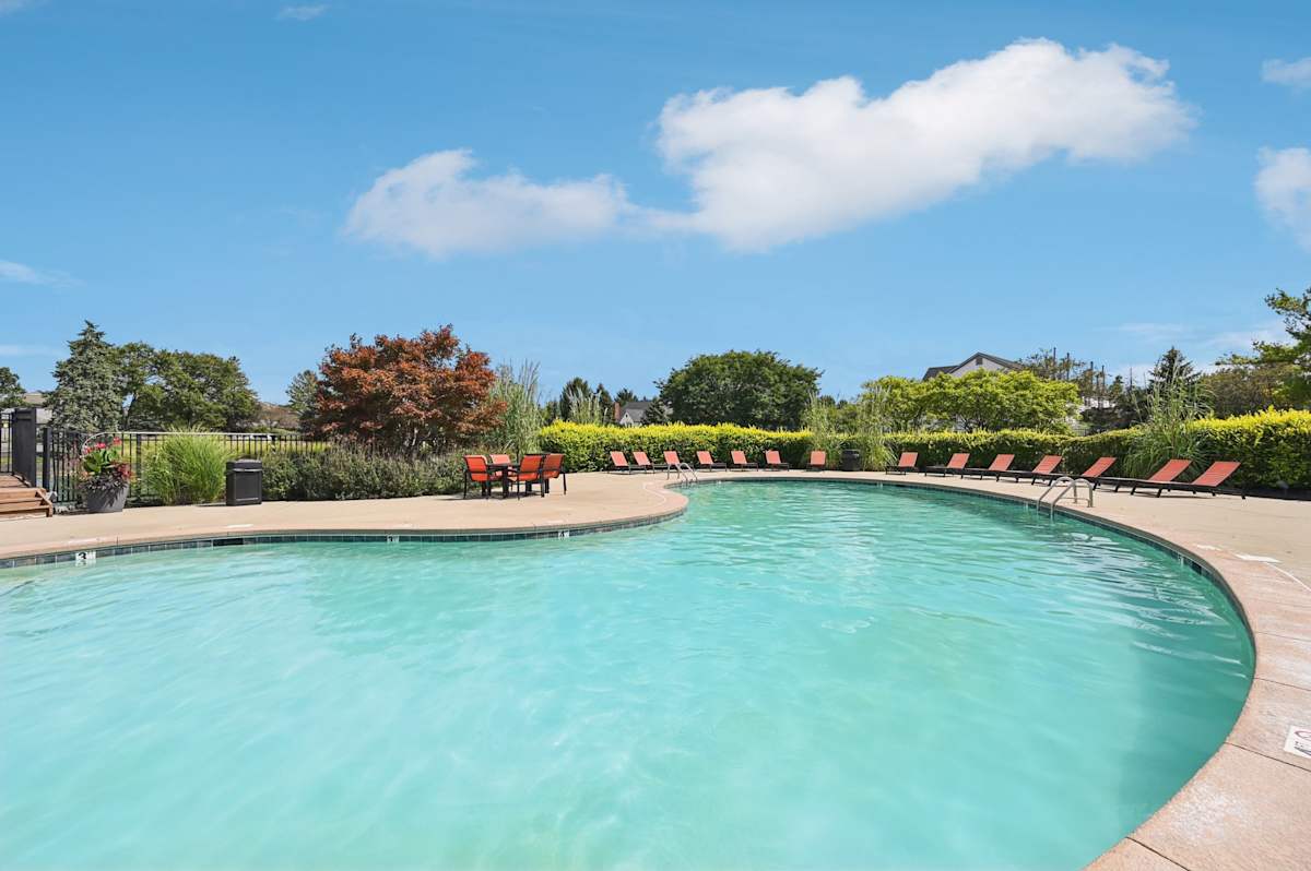 Island Club Apartments resort-style pool with red loungers - Columbus, OH