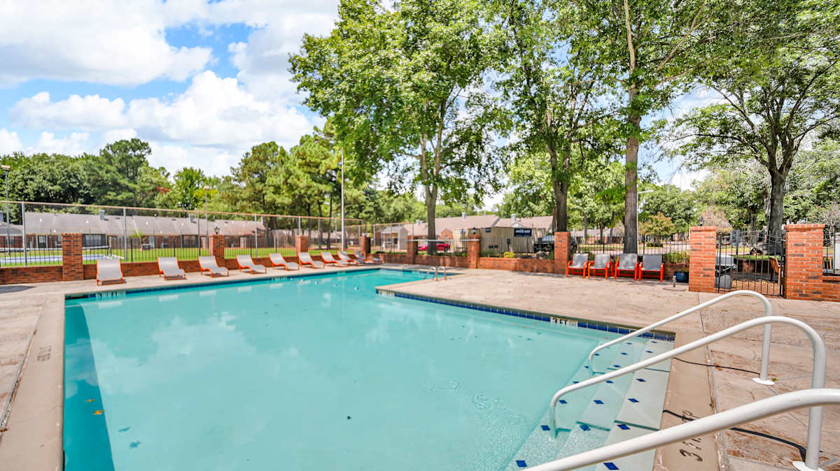 The Birches Apartment Homes pool with lounge chairs - Memphis, TN