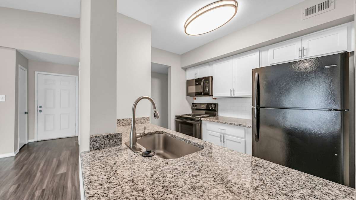 The Nova Apartments kitchen with refrigerator and sink - Memphis, TN