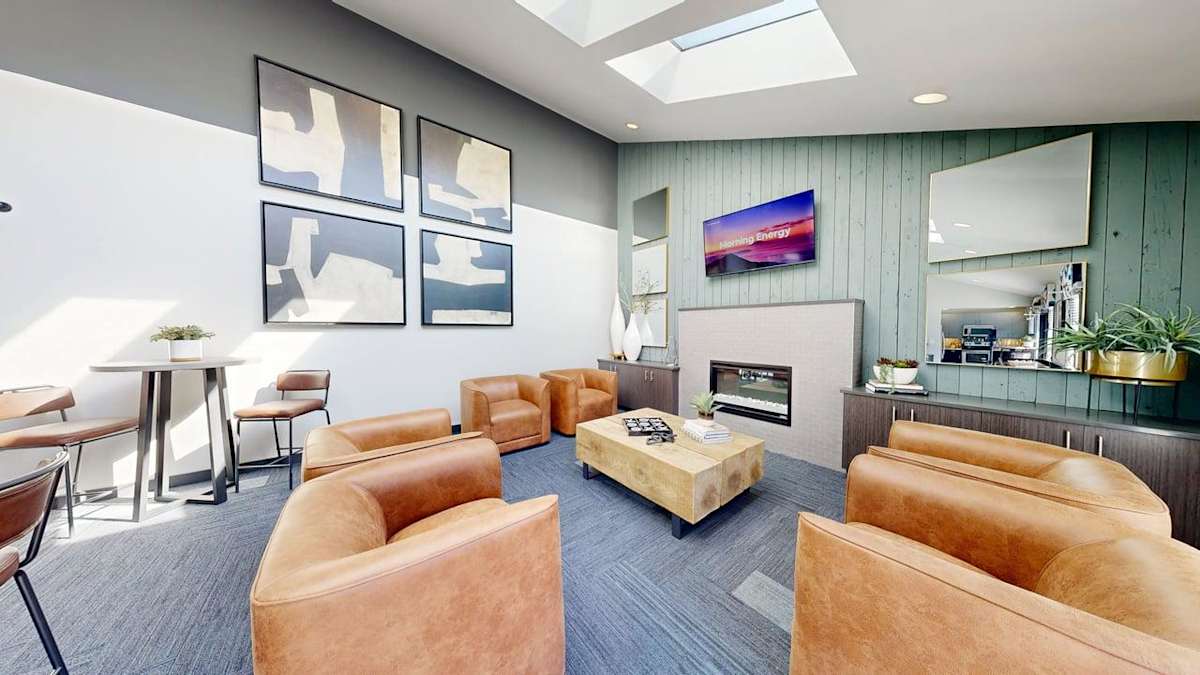 Ellyson Apartment Homes clubhouse lounge with TV and skylight - Tacoma, WA