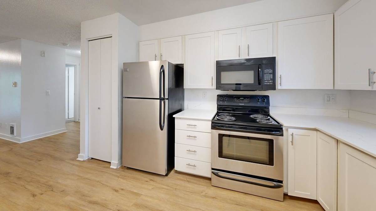 Ellyson Apartment Homes kitchen with refrigerator, oven, and microwave - Tacoma, WA