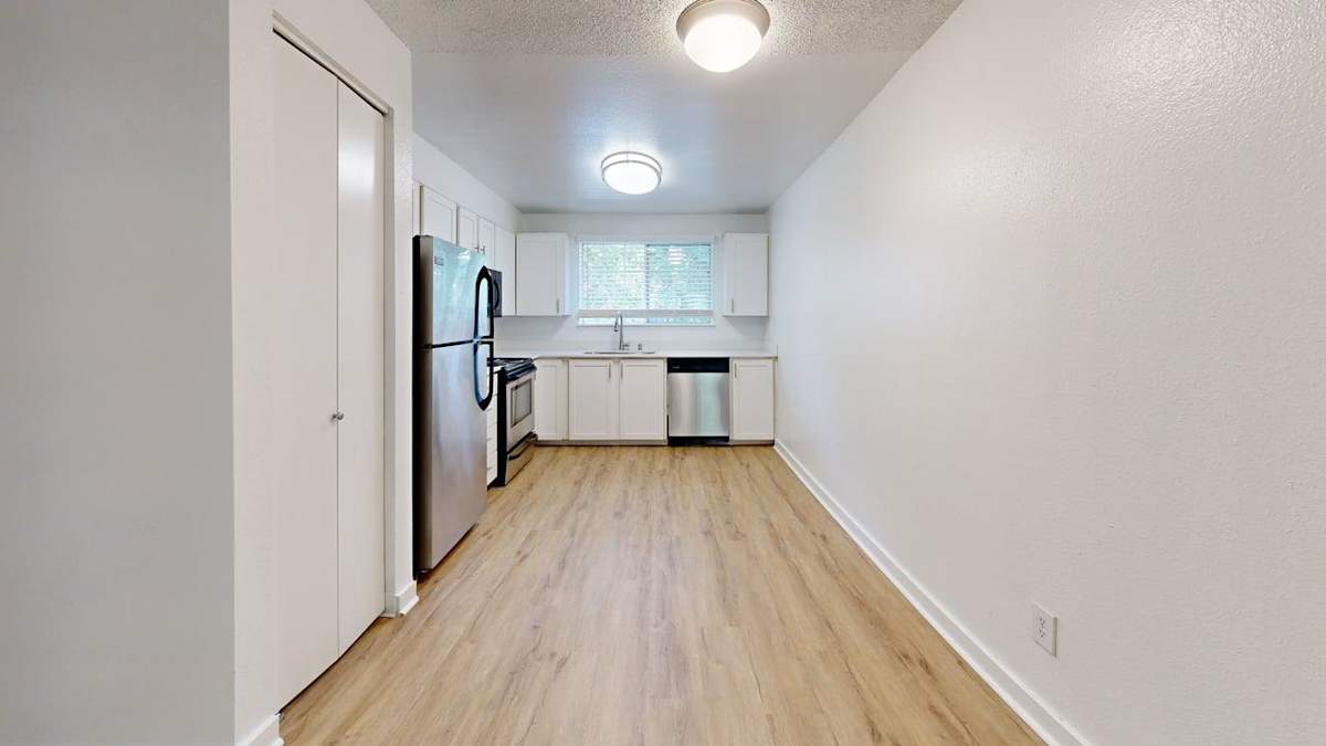 Ellyson Apartment Homes kitchen with refrigerator and sink - Tacoma, WA