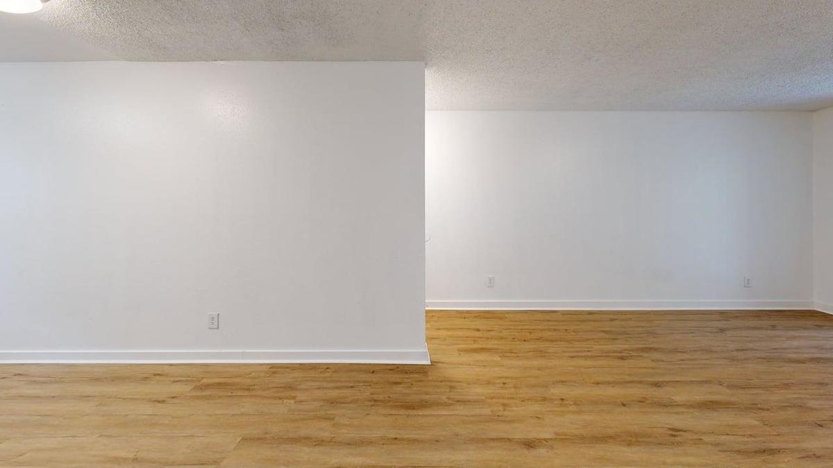 Ellyson Apartment Homes living room with wood-style flooring - Tacoma, WA