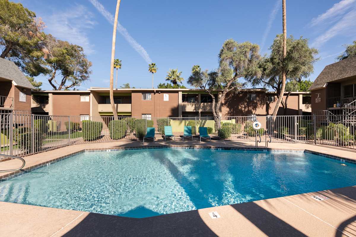 Pool and poolside area at Arcadia Villa Apartments.