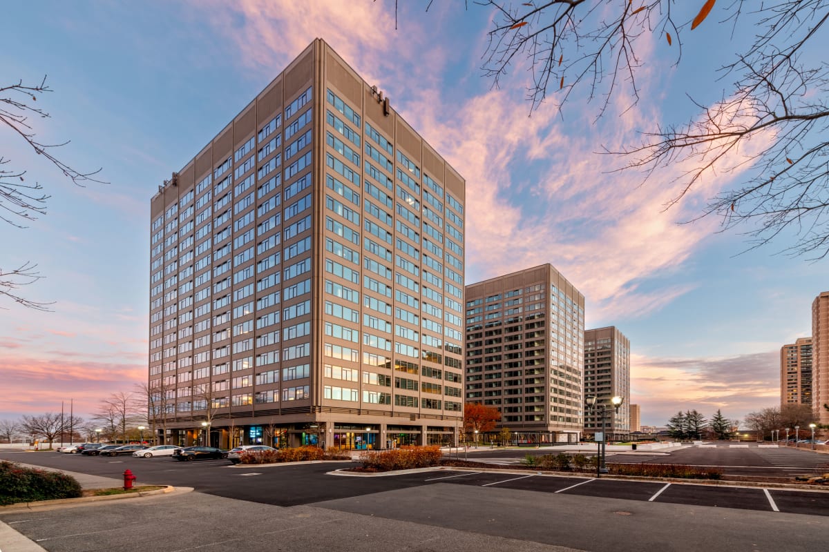 Three Collective leasing office building exterior at dusk - Falls Church, VA