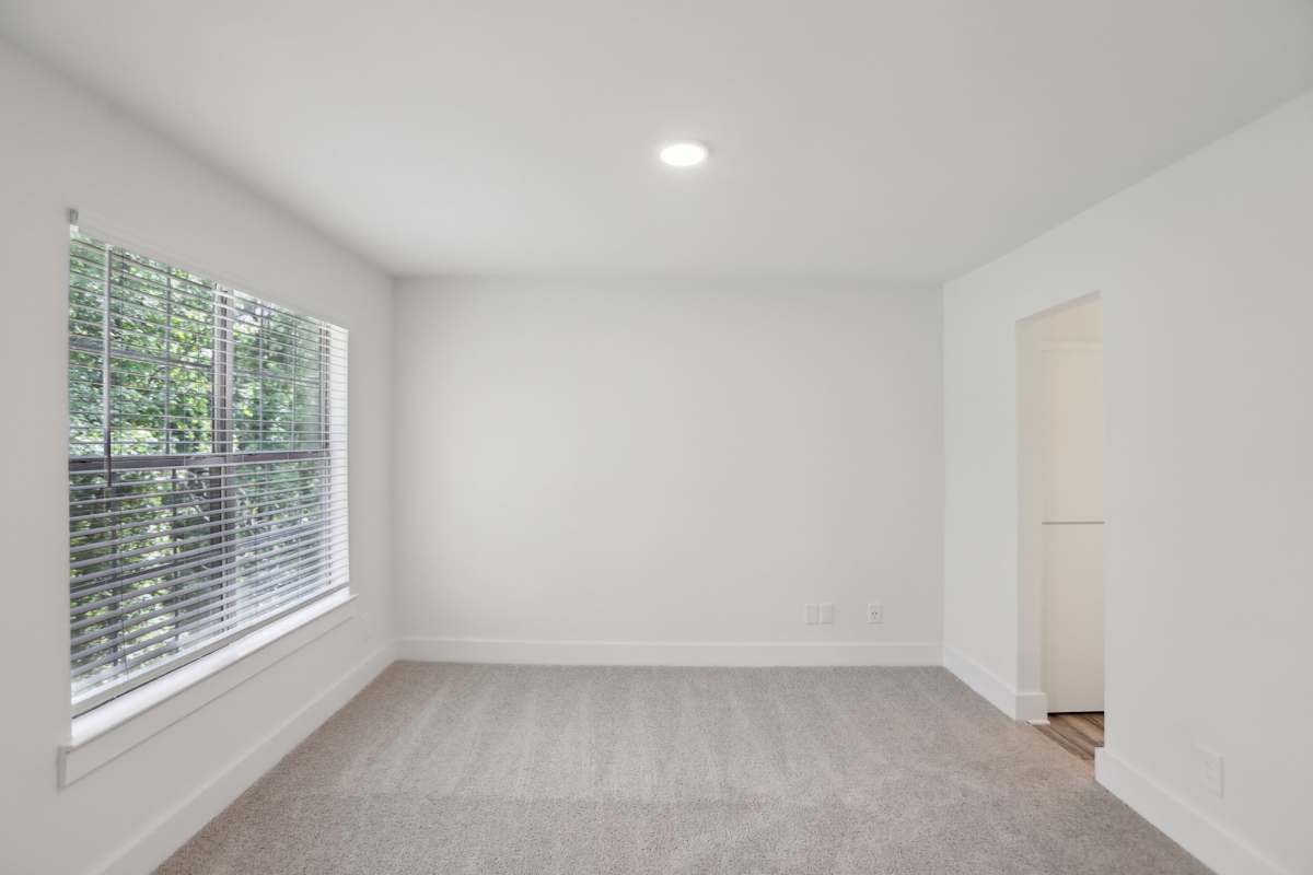 Arbor Mill Apartments at Norcross bedroom with window and carpet - Norcross, GA