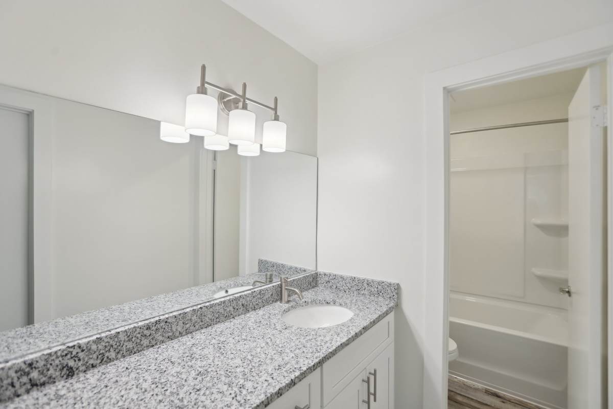 Arbor Mill Apartments at Norcross bathroom vanity with granite countertop - Norcross, GA