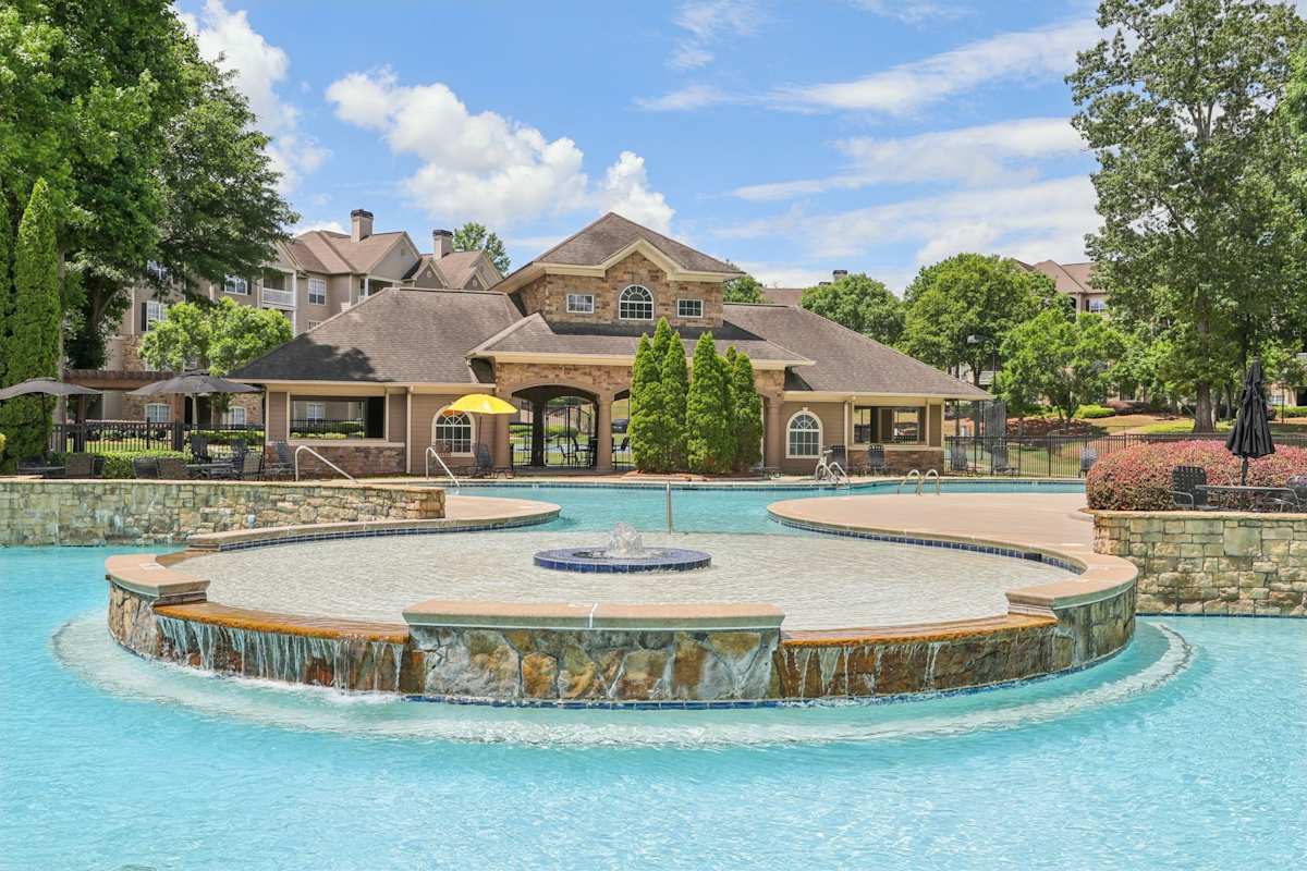 Wesley Providence Apartments at Stonecrest lagoon-style swimming pool with lounge seating - Stonecrest, GA