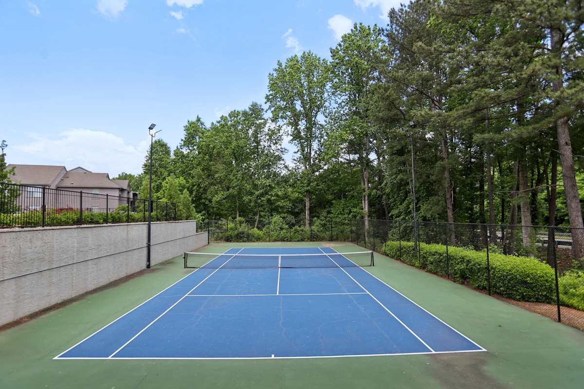 Arbor Mill Apartments at Norcross tennis court surrounded by landscaping - Norcross, GA