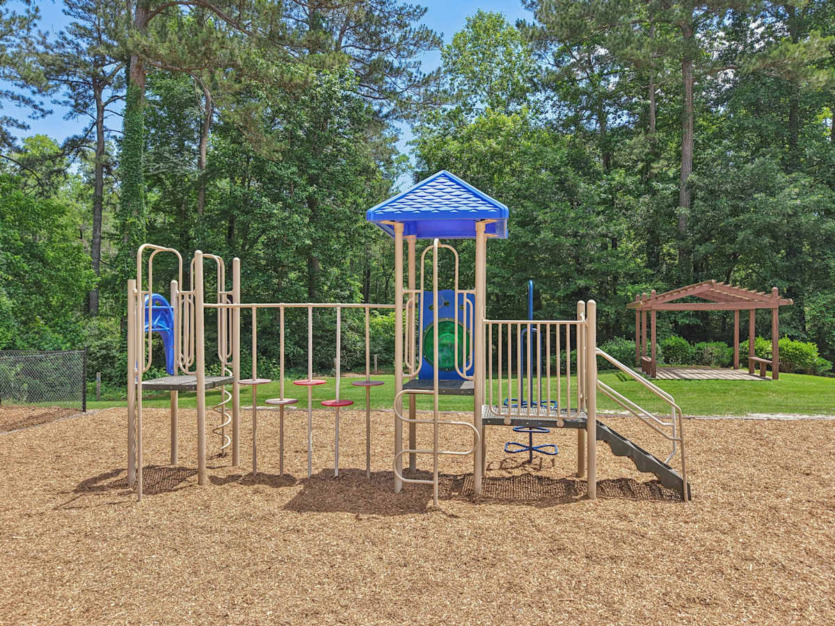 Wesley Trevento Apartments at Lithia Springs playground with slides and climbing bars - Lithia Springs, GA