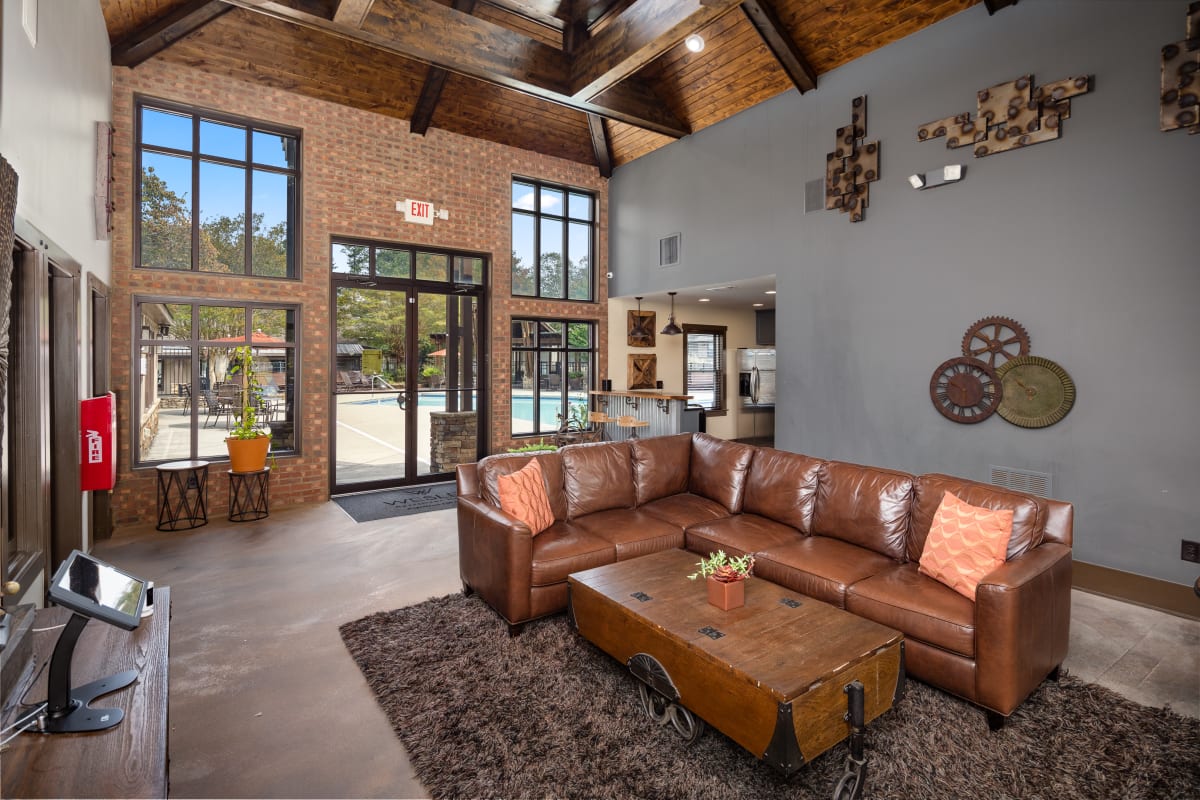 Wesley Trevento Apartments at Lithia Springs clubhouse with leather sectional and fireplace - Lithia Springs, GA