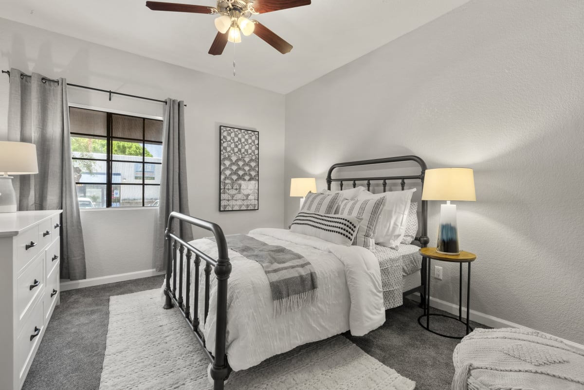 Furnished bedroom shown — representative home at Vaseo Apartments.
