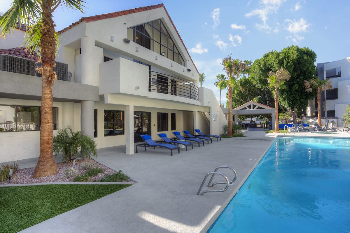 Pool and poolside area at Vaseo Apartments.