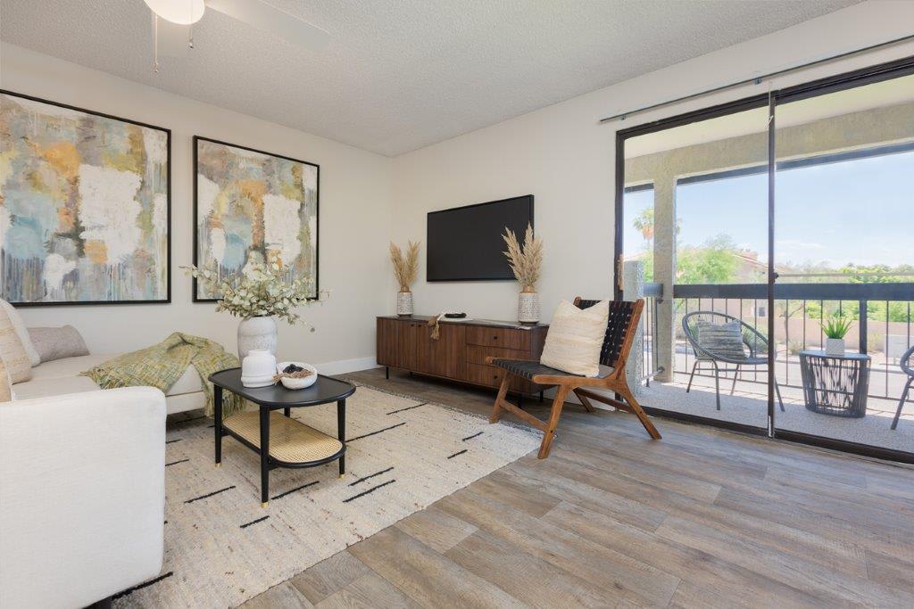 Furnished apartment living area shown — representative home at Reveal.