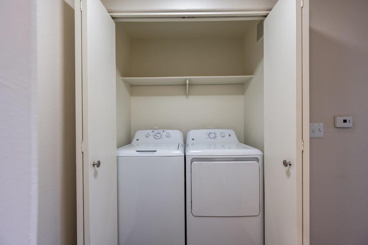 In-home laundry area — representative home at Bayside Apartments.