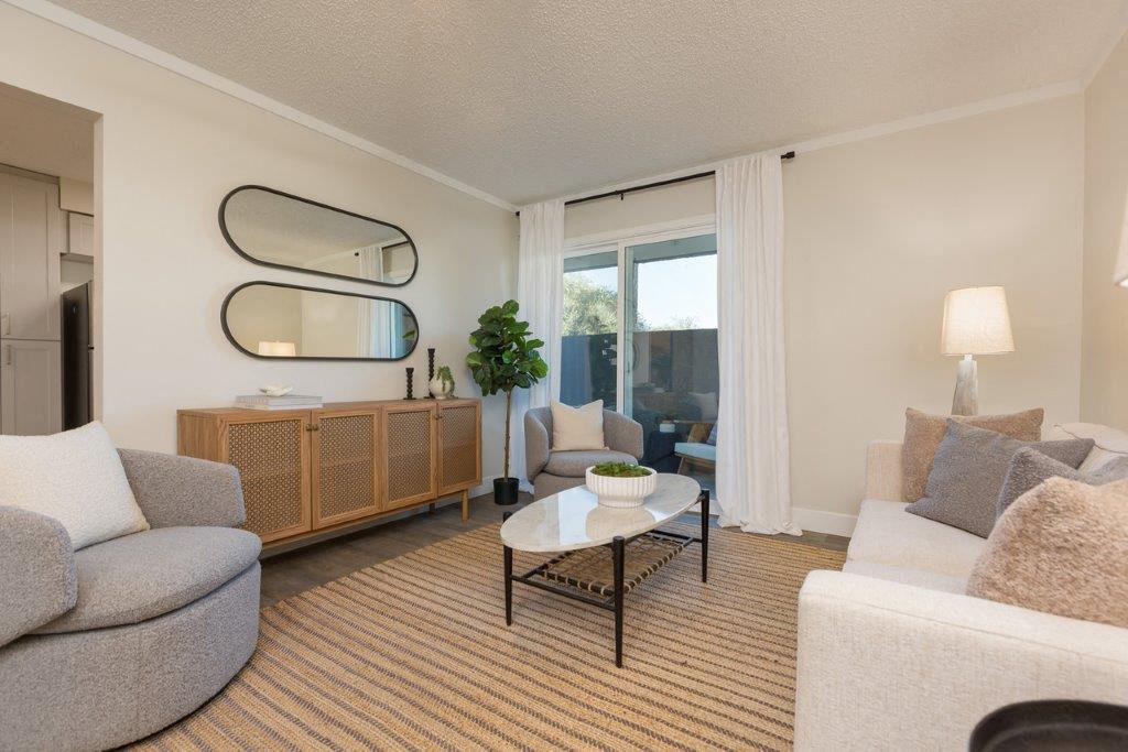 Furnished apartment living area shown — representative home at Reveal.