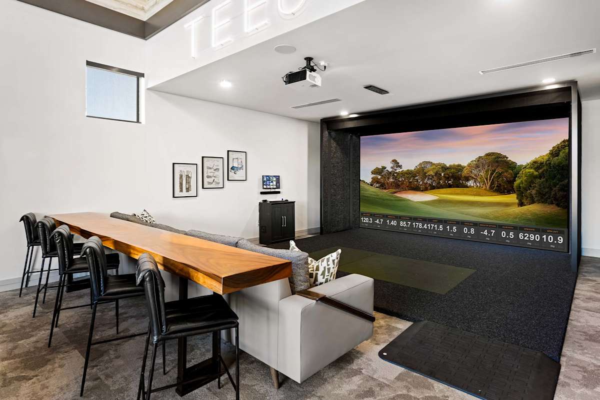 Golf simulator and shared table at Elysium.