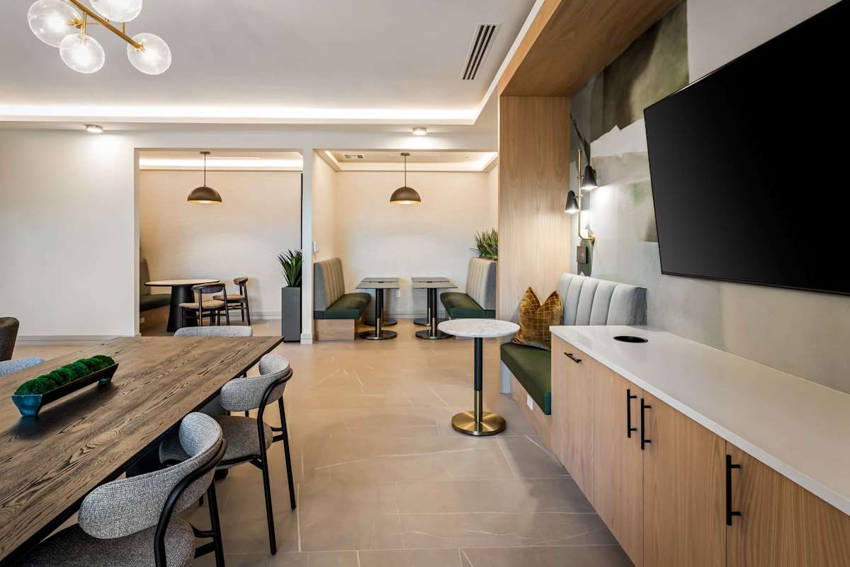 Shared dining table and kitchenette at Elysium.