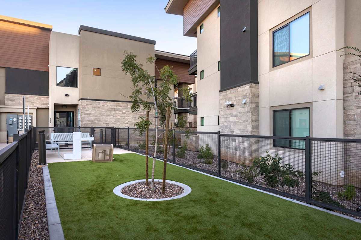 Apartment buildings beside a fenced lawn at Elysium.