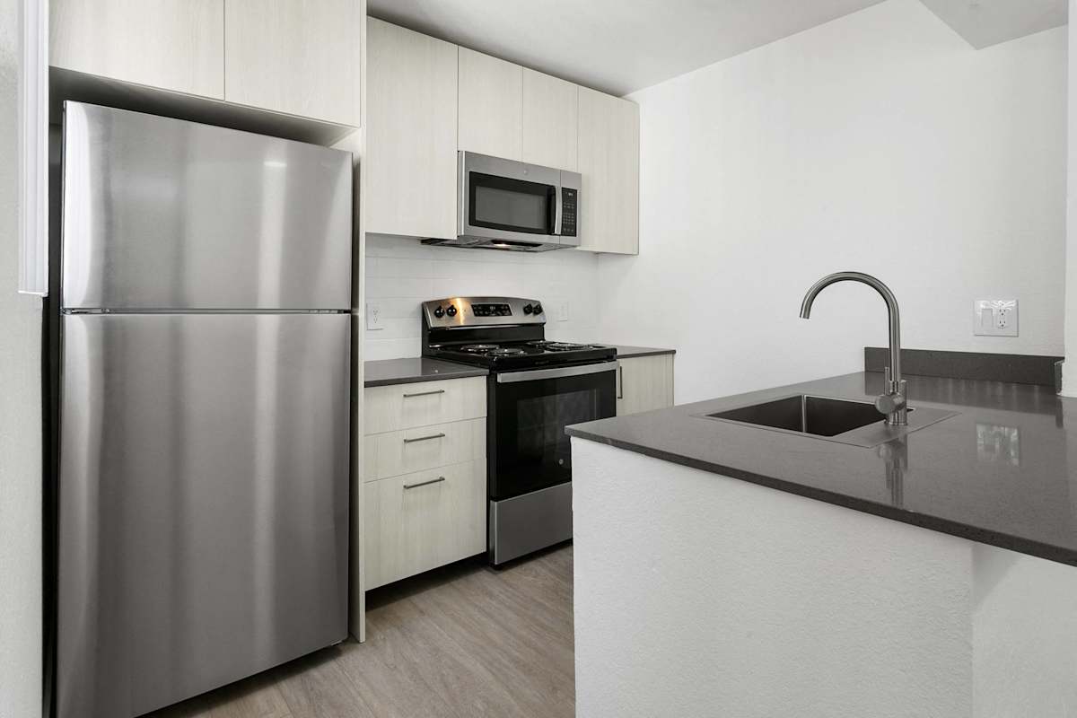 Apartment kitchen — representative home at Villa de Cortez.