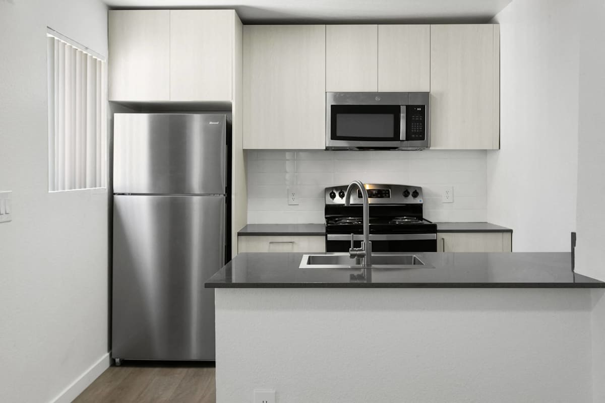 Apartment kitchen — representative home at Villa de Cortez.