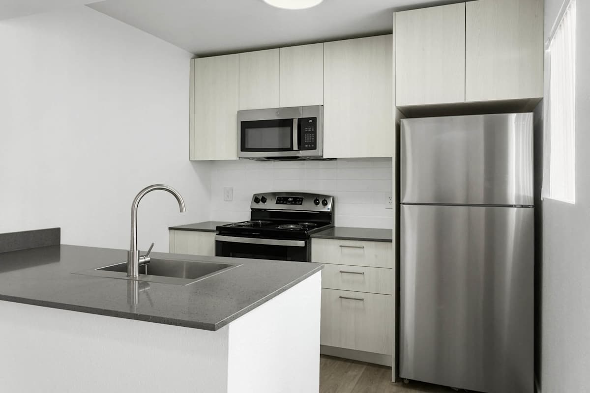 Apartment kitchen — representative home at Villa de Cortez.