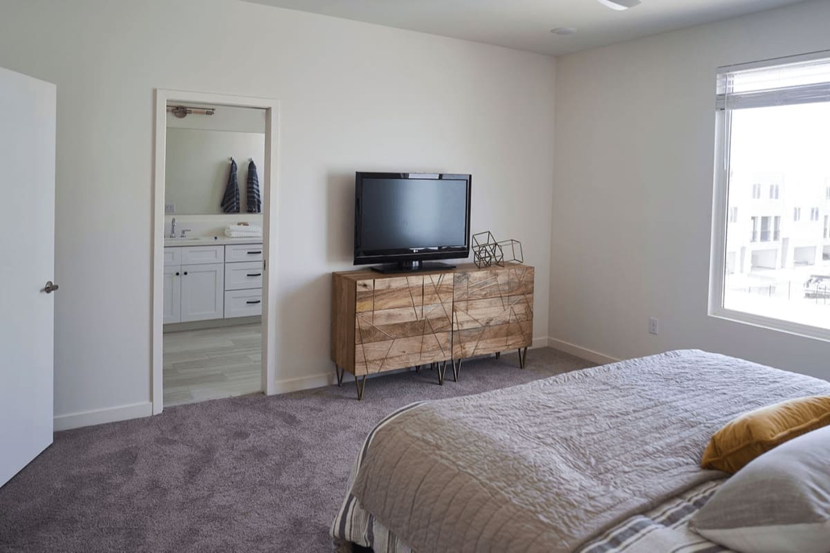 Furnished bedroom shown — representative home at Novella at Biltmore.