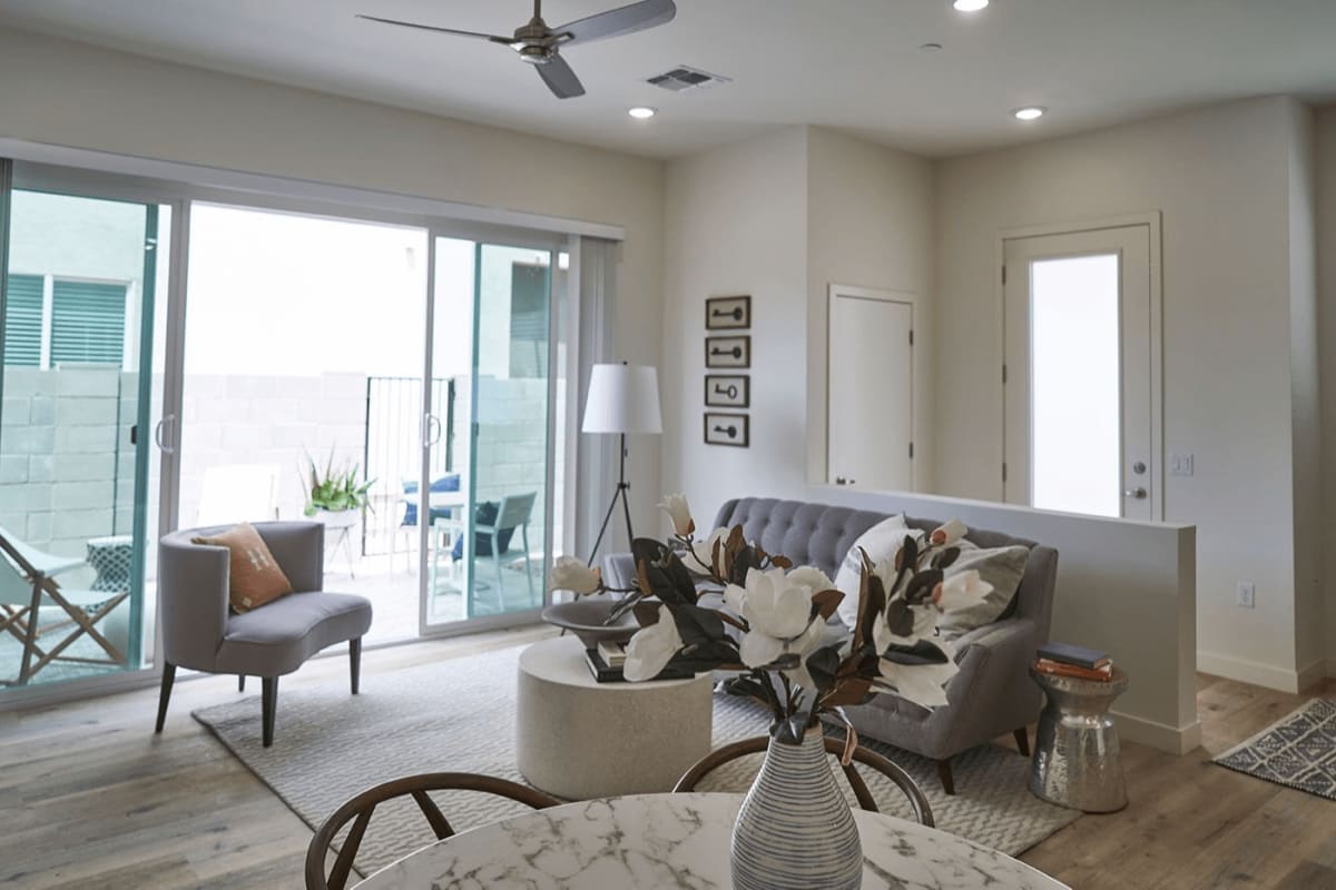 Furnished apartment living area shown — representative home at Novella at Biltmore.