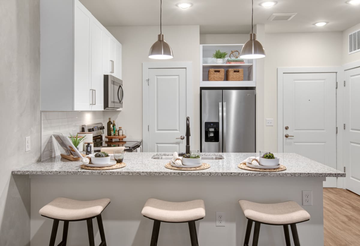 Celadon on Club Apartments kitchen with granite counters and stainless appliances - Lawrenceville, GA