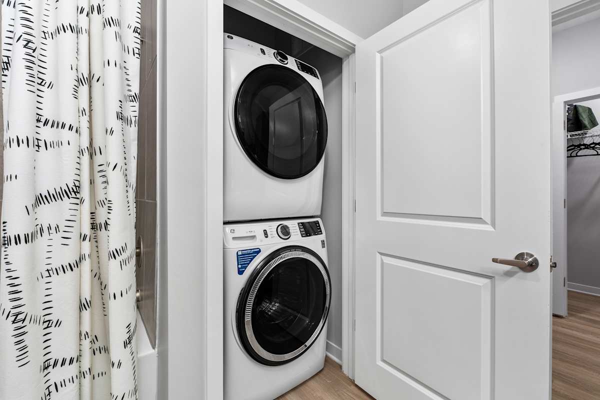 Arcadia Apartments in-home laundry closet with washer - Huntsville, AL