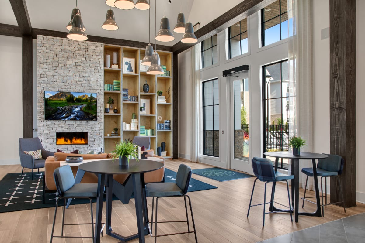 Celadon on Club Apartments clubroom with seating and fireplace - Lawrenceville, GA
