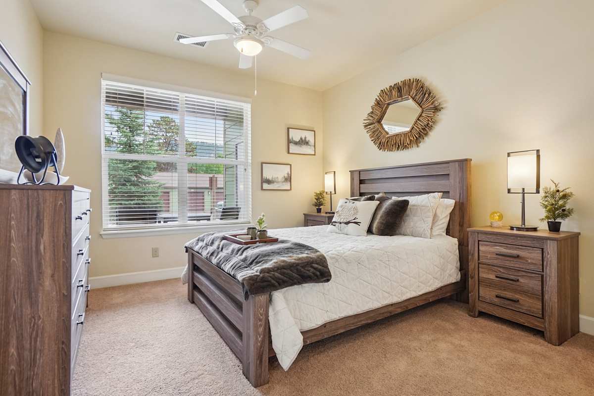 Trail Ridge at Woodland Park Apartments bedroom with ceiling fan - Woodland Park, CO