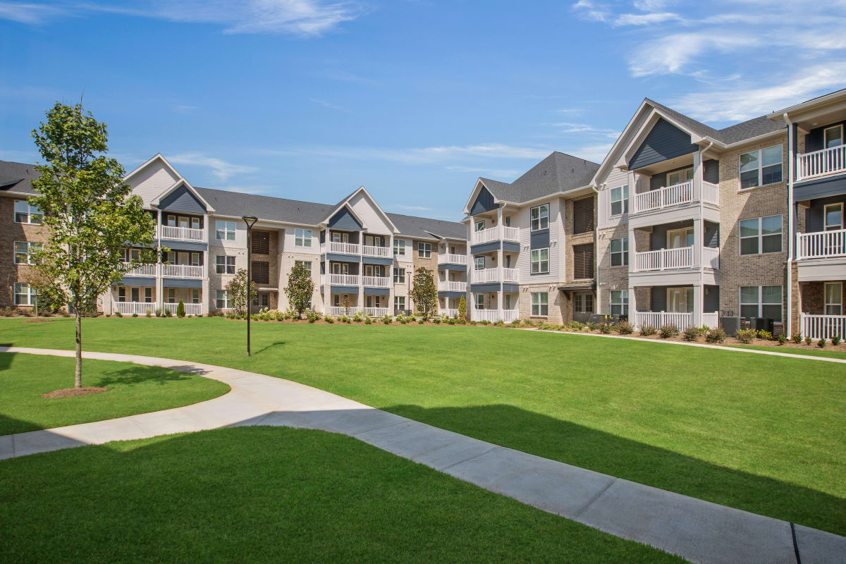Celadon on Club Apartments exterior with green lawn - Lawrenceville, GA