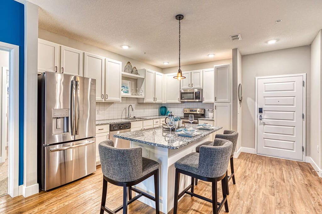 The Parker at Maitland Station Apartments kitchen with island seating and pendant lighting - Maitland, FL