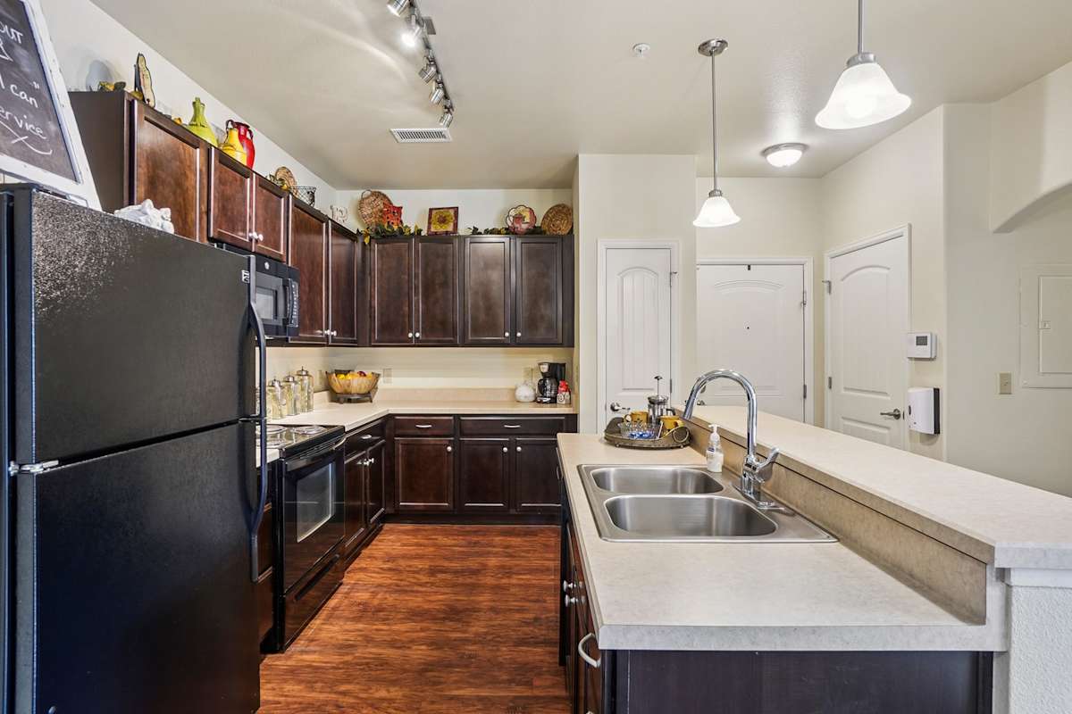 Trail Ridge at Woodland Park Apartments kitchen with wood cabinetry - Woodland Park, CO